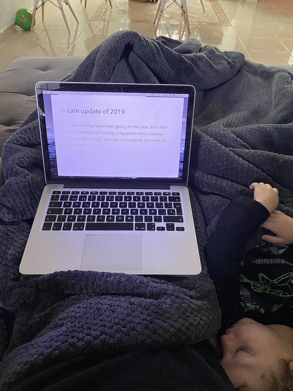 Writing at the couch with my sleeping kid